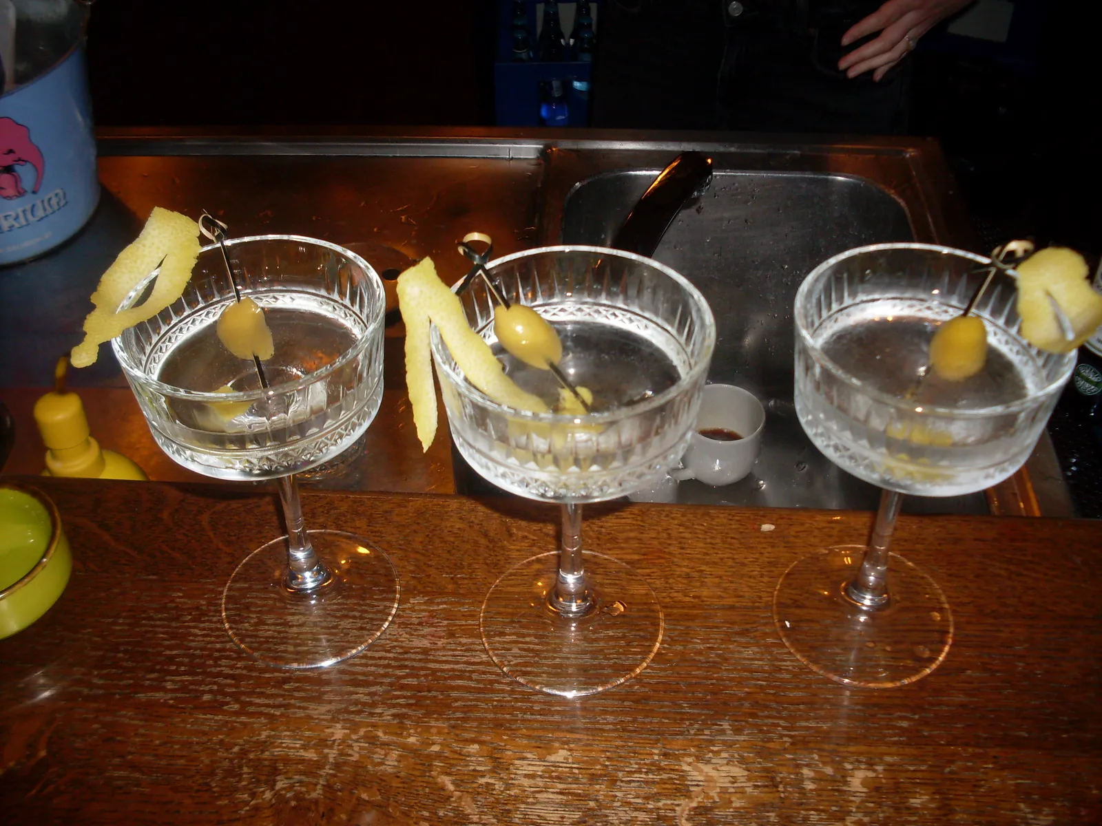 Three finished cocktails with citrus garnish on the bar at Vanagai in Vilnius Old Town